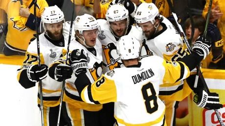 Pittsburgh Penguins' Sidney Crosby celebrates with teammates after scoring a goal against Pekka Rinne during the first period of Game 4 on Monday night. penguins-predators