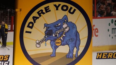 A sign showing Stanley the Blue Dog hangs in the Nashville Predators' locker room is a symbol of how the Predators attack each moment like a dog defending his bone. stanley-dog-060617