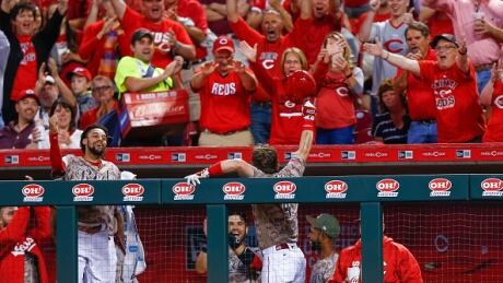 Scooter Gennett of the Cincinnati Reds acknowledges the hometown crowd after hitting his third home run in the eighth inning against the St. Louis Cardinals. gennett-scooter-060617
