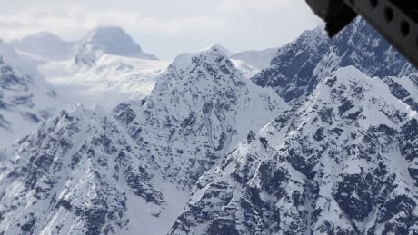 This April 24, 2016, file photo taken above the Kahiltna Glacier near Denali, shows peaks in the Alaska Range, as seen through the open cargo bay doors of a Chinook helicopter. Rangers rescued two climbers in unrelated incidents from Kahiltna Glacier in Denali National Park on Monday, June 5, 2017. Climbers Rescued