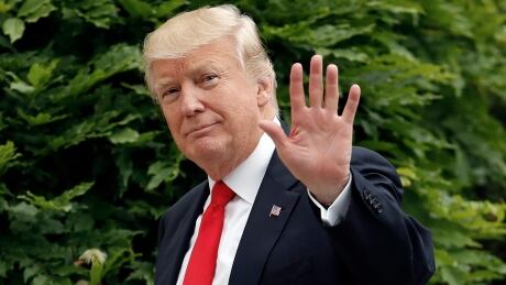 President Donald Trump waves as he walks back into the White House in Washington after returning from a trip to Cincinnati. He did not answer reporters' questions asking for reaction to Comey's pre-released testimony. Trump