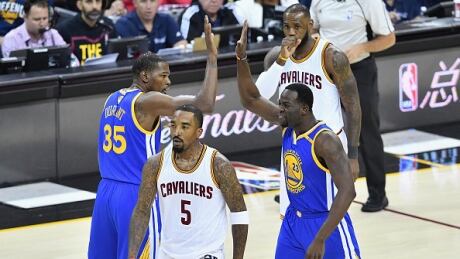 Golden State Warriors' Kevin Durant and Draymond Green celebrate after a play in the first quarter against the Cleveland Cavaliers in Game 3. nba-finals