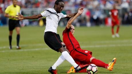 Michael Bradley of the U.S. blocks Trinidad & Tobago's Alvin Jones during the Americans' 2-0 win in World Cup qualifying. WCup Trinidad US Soccer