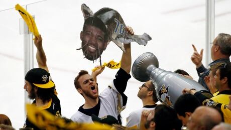 Some Penguins fans wanted to show their distaste for the Predators' P.K. Subban, with this fan holding a catfish sign adorned with the face of the Nashville defenceman. Stanley Cup Predators Penguins Hockey