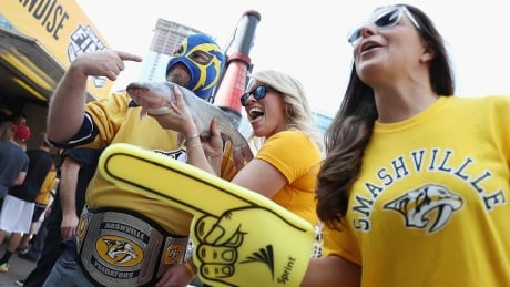 NASHVILLE, TN - JUNE 03: Nashville Predators fans pose with a catfish prior to Game Three of the 2017 NHL Stanley Cup Final between the Pittsburgh Penguins and the Nashville Predators at the Bridgestone Arena on June 3, 2017 in Nashville, Tennessee. (Photo by Patrick Smith/Getty Images) predators-fans-170603-1180