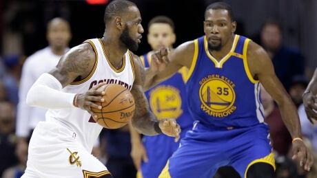 Cleveland Cavaliers forward LeBron James, left, drives on Golden State Warriors forward Kevin Durant during Game 4 of the NBA Finals in Cleveland on Friday. cavaliers-warriors-nba-finals-060917-620