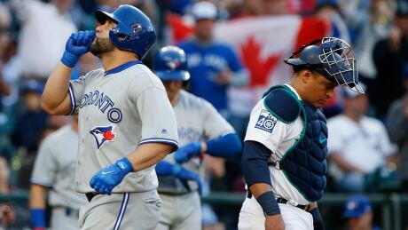 Kendrys Morales, left, comes home after hitting a two-run home run in the fourth inning against the Seattle Mariners on Saturday evening. kendrys-morales