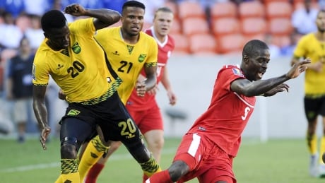 Canada's Tosaint Ricketts is tripped by Jamaica's Kemar Lawrence (20) during 2015 CONCACAF Gold Cup action. Canada-Jamaica-11072015