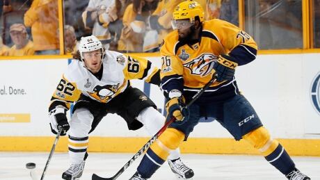 Nashville Predators defenceman P.K. Subban sends a pass as Pittsburgh Penguins' Carl Hagelin closes in during the first period. subban-pk