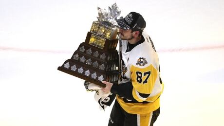 Pittsburgh Penguins captain Sidney Crosby celebrates with the Conn Smythe Trophy after they defeated the Nashville Predators 2-0. crosby-sidney