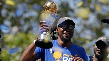 Golden State's Kevin Durant shows off his Finals MVP trophy during the team's championship parade Thursday in Oakland. APTOPIX Warriors Parade Basketball