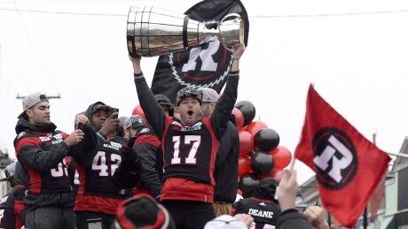 Ottawa Redblacks' Ronnie Pfeffer holds the Grey Cup during a parade celebrating the team's victory over the Calgary Stampeders on Nov. 29, 2016 in Ottawa. reblacks-112916-620