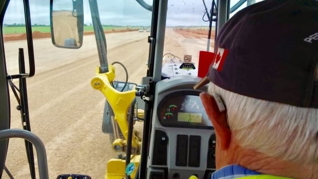 Roland Bushey inside his grader