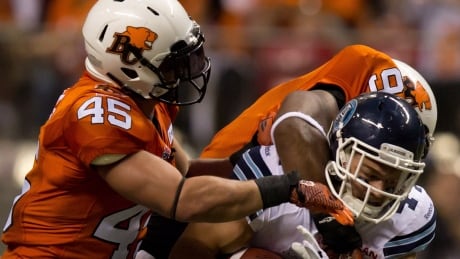 B.C. Lions' Jason Arakgi, left, will retire as the CFL's all-time leader in special teams tackles. CFL Argonauts Lions 20130704