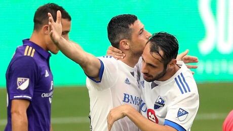 Montreal Impact's Blerim Dzemaili, middle, celebrates with Matteo Mancosu after Dzemaili scored a goal against Orlando City. impact-orlando-city