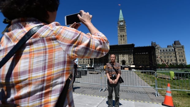 Chinese tourists vist Parliament Hill in Ottawa on Wednesday