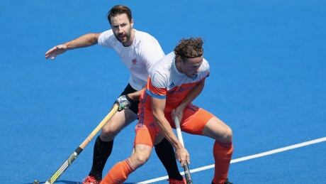 Bob de Voogd of the Netherlands, right, handles the ball against Canada during Monday's 3-1 win in Field Hockey World League action from London, England. netherlands-canada
