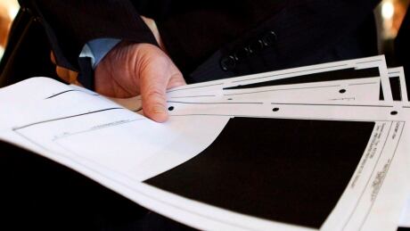Blacked-out pages from an Afghan detainee document are seen in Ottawa on Thursday March 25, 2010. The Conservatives' new draft plan on open government makes no mention of reforming the Access to Information Act, despite widespread calls to revise the 32-year-old law. Open Government 20141010