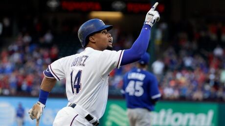 Texas Rangers' Carlos Gomez points skyward as he approaches the plate after hitting a solo home run off of Toronto Blue Jays' Francisco Liriano during the first inning. blue-jays