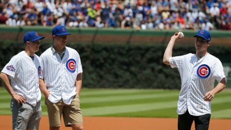 Top-ranked NHL prospect Nolan Patrick throws out the first pitch at Wrigley Field Wednesday as fellow prospects Casey Mittlestadt and Gabriel Vilardi look on. Padres Cubs Baseball