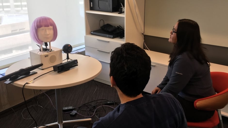 A couple gets counselling from a humanoid robot.