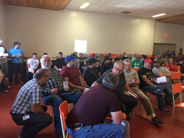 Fishermen inside fire hall