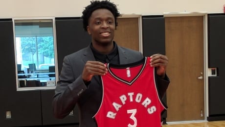 Raptors draft pick OG Anunoby shows off his jersey Friday in Toronto. og-anunoby
