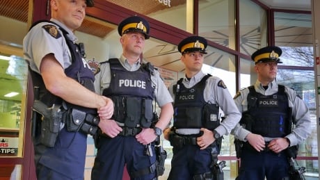 Members of the North Vancouver RCMP wear plain navy cargo pants, removing the traditional yellow stripe in protest. rcmp yellow stripes removed