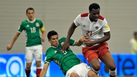 Cyle Larin, right, fights for the ball against Mexico in the 2018 FIFA World Cup Concacaf qualifiers in March, 2017. Facing drunk-driving charges, Larin was left off Team Canada's roster for the Gold Cup. Larin-Cyle-03292016