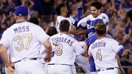 Kansas City Royals' Whit Merrifield, top right, is mobbed by teammates after hitting a walk-off two-run double during the ninth inning on Friday. The Royals stunned the Toronto Blue Jays in a come-from-behind 5-4 victory. Blue Jays Royals Baseball
