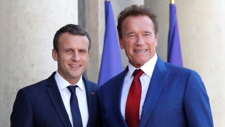 Former California Governor Arnold Schwarzenegger (R) is greeted by French President Emmanuel Macron (L) upon his arrival at the Elysee Palace in Paris, France, June 23, 2017. FRANCE-CLIMATECHANGE/