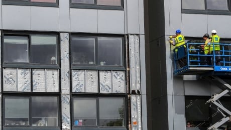 Workers remove cladding from Whitebeam Court, in Pendleton, Manchester on Monday. The list of high-rise apartment towers in Britain that have failed fire safety tests grew to 60, officials have said, while Arconic announced it will stop production of the controversial high-rise paneling. Britain London Fire