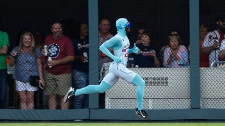 Atlanta Braves grounds crew member and former college track star Nigel Talton races a fan from the left field corner to the right field corner during Atlanta Braves "Beat The Freeze" promotion during a baseball game against the Miami Marlins Friday, June 16, 2017, in Atlanta. (AP Photo/John Bazemore) Braves The Freeze