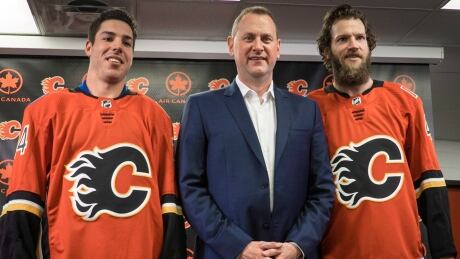 Calgary Flames general manager Brad Treliving, centre, introduces goalie Mike Smith, right, and defenceman Travis Hamonic on Monday. HKN Flames Hamonic Smith 20170626