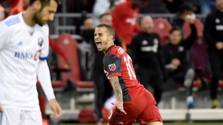Toronto FC's Sebastian Giovinco celebrates his first of two second-half goals in front of a dejected Impact forward Matteo Mancosu during FC's 2-1 win in the Canadian championship. SOC Impact Toronto FC 20170627
