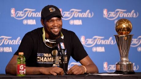 Kevin Durant, pictured with his NBA Finals MVP after his Warriors won the championship earlier this month, will opt out of his contract but is expected to re-sign with Golden State. 700056191RR00264_2017_NBA_F