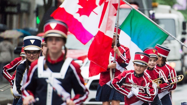 Montreal's Canada Day parade cancelled after organizer pulls plug; A marching band entertains the crowd along Ste-Catherine Street\.