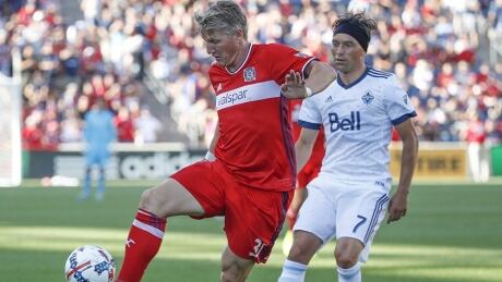 Bastian Schweinsteiger, left, of the Fire controls, while Christian Bolanos of the Whitecaps defends during Chicago's 4-0 win over Vancouver on Saturday. Whitecaps-Fire-01072017