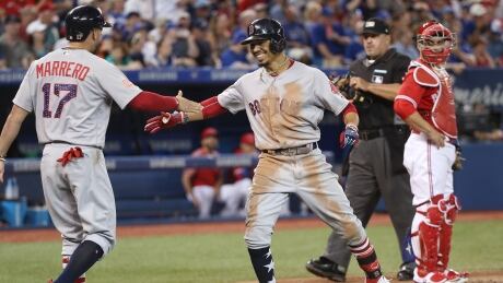 Mookie Betts, right, drove in 8 runs on Sunday afternoon as the Boston Red Sox defeated the Toronto Blue Jays to sweep the three-game series. mookie-betts-620