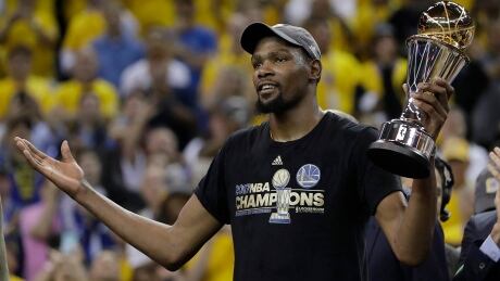 Golden State Warriors forward Kevin Durant gestures as he holds the Bill Russell NBA Finals Most Valuable Player Award after Game 5. durant-kevin