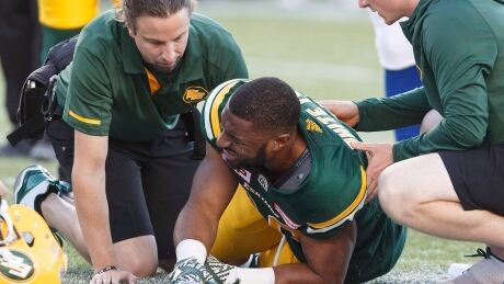 Edmonton Eskimos' John White (30) is injured during first half CFL action against the Montreal Alouettes. white-john