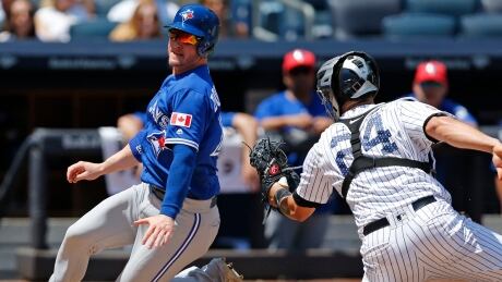 Toronto's Josh Donaldson evades Gary Sanchez's tag to score during the Jays' 4-1 win Tuesday in New York. Blue Jays Yankees Baseball