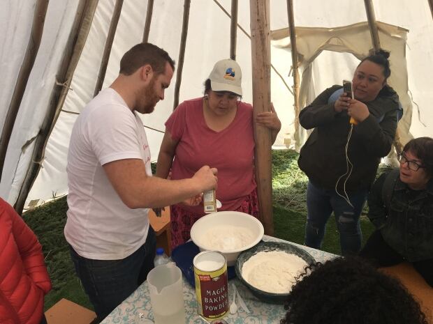 C3 staff Emmett MacDougal and participants learn to make bannock