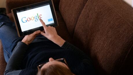 This picture taken on May 13, 2013 in the French western city of Rennes shows a woman choosing Google Search (or Google Web Search) web search engine front page on her tablet. A report by a French expert panel published on May 13, 2013 recommended imposing taxes on smartphones and tablets but rejected a call for search engine Google to be charged for linking to media content. The nine-member panel, headed by respected journalist and businessman Pierre Lescure, said in the keenly awaited report that the revenue gained from the proposed new taxes could help fund artistic and creative ventures. AFP PHOTO / DAMIEN MEYER (Photo credit should read DAMIEN MEYER/AFP/Getty Images) Par7556363