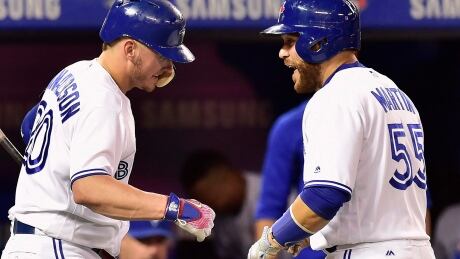 Blue Jays catcher Russell Martin, right, is congratulated by Josh Donaldson after his solo home run against the Houston Astros on Thursday. BBA Astros Blue Jays 20170706