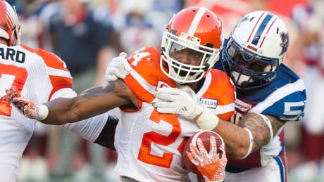 Montreal Alouettes defensive end Gabriel Knapton, right, tackles B.C. Lions running back Jeremiah Johnson during the first half in Montreal on Thursday. lions-alouettes-070617-620