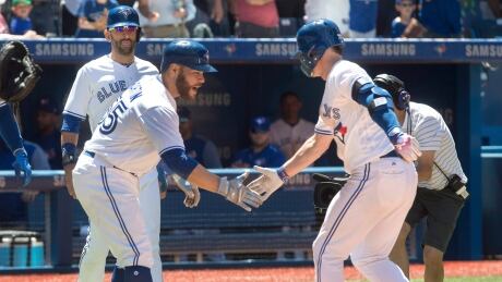 Toronto Blue Jays catcher Russell Martin, left, congratulates teammate Josh Donaldson after he hit a three-run home run against the Houston Astros in the fifth inning in Toronto on Saturday. blue-jays-astros-070817-620