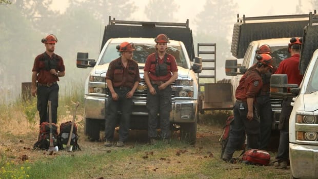 Firefighters take a breather while battling an out-of-control wildfire near Princeton, B.C.