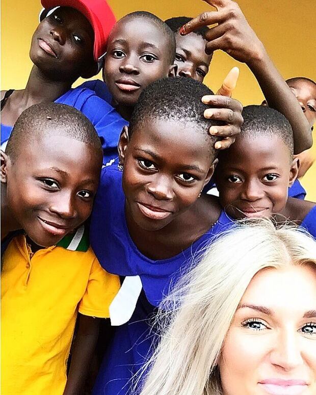 Kaylyn Kyle with young boys in Ghana