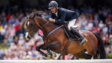 Richard Spooner, of the United States, riding Cristallo, is pictured above in Nexen Cup Derby during the National show jumping competition at Spruce Meadows in Calgary, Alta., Sunday, June 11, 2017. spooner-richard